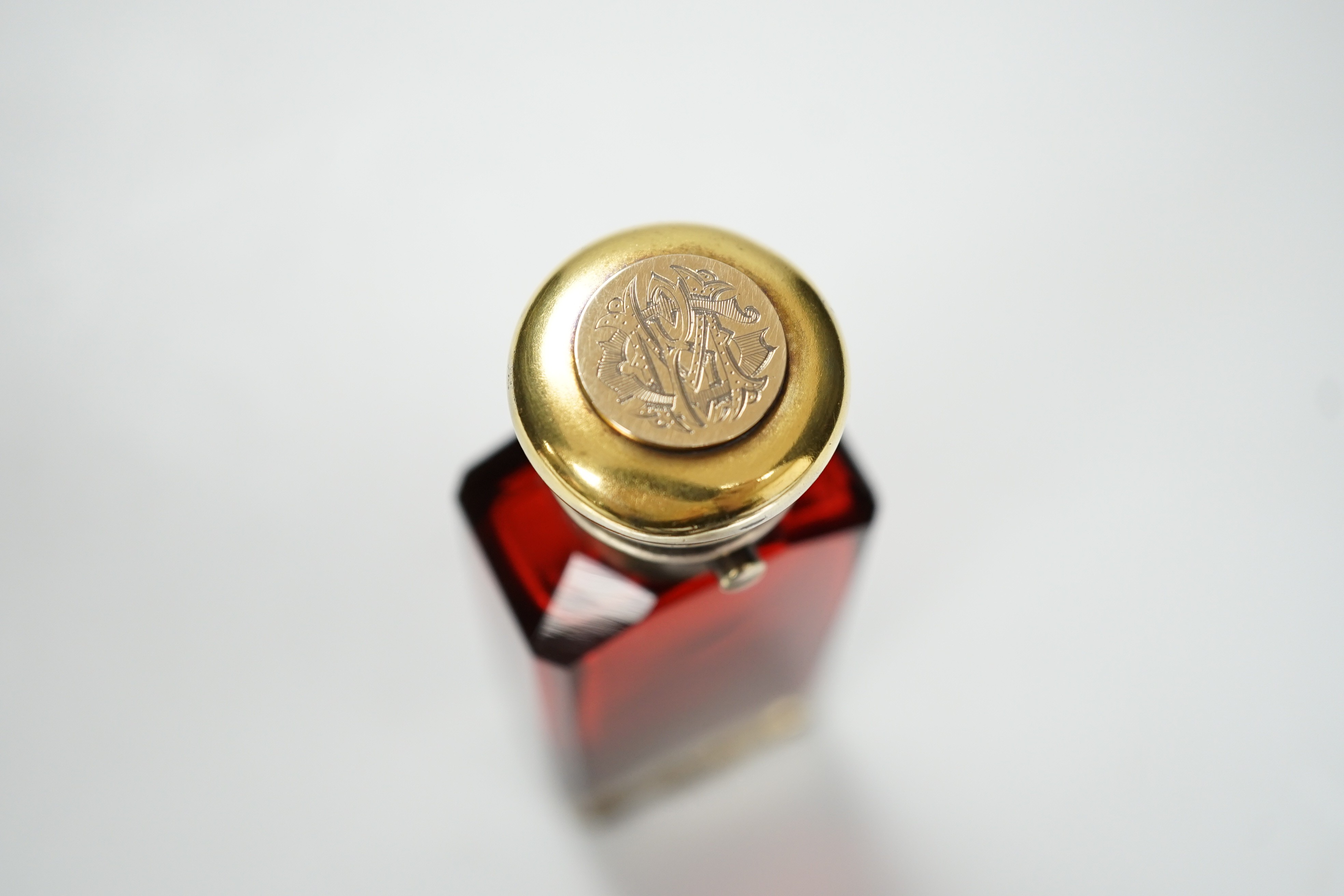 A late Victorian silver gilt mounted ruby glass combination scent bottle/vinaigrette, by Sampson Mordan & Co, London, 1877, 96mm.